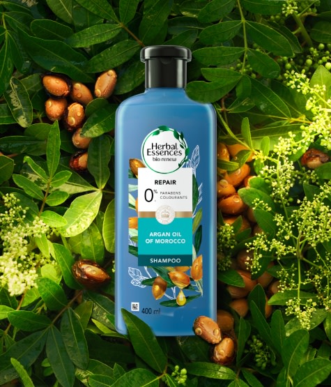 Herbal Essences Argan Oil shampoo with argan ingredients in the background