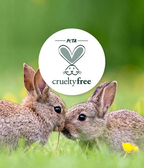 PETA logo above two small rabbits sitting on grass