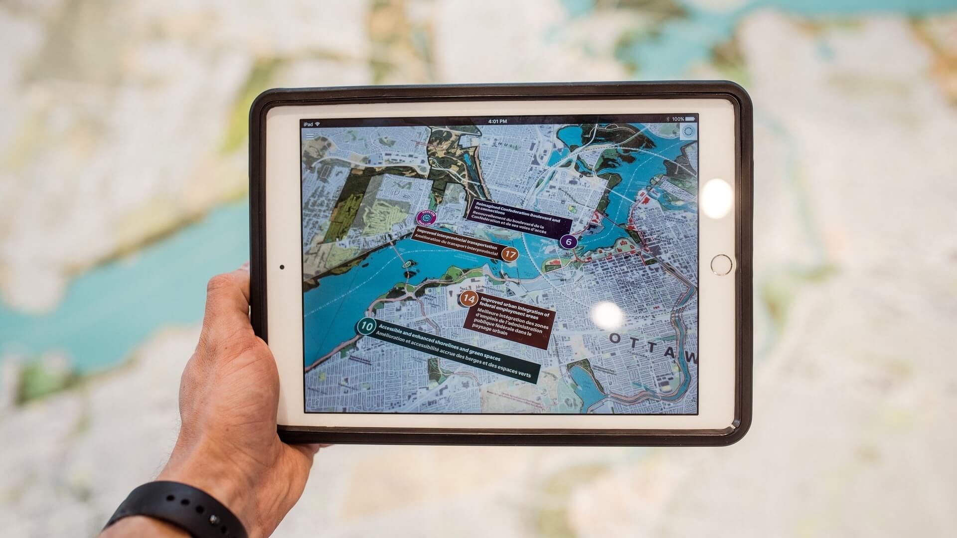 Point of view of person holding ipad with map on it.
