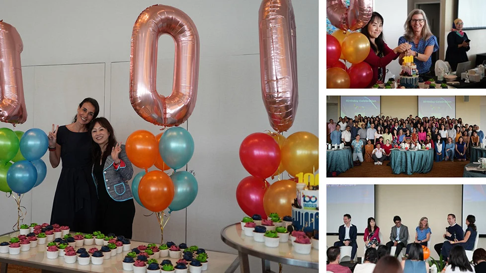 4 pictures: 1) Olga and Yoshimi-san in behind a “100” balloon display 2) Julie and Nakamura-san jointly cutting the 100th year anniversary cake 3) a large group photo fo the offsite attendees 4) The panelists enjoying the panel discussion onstage