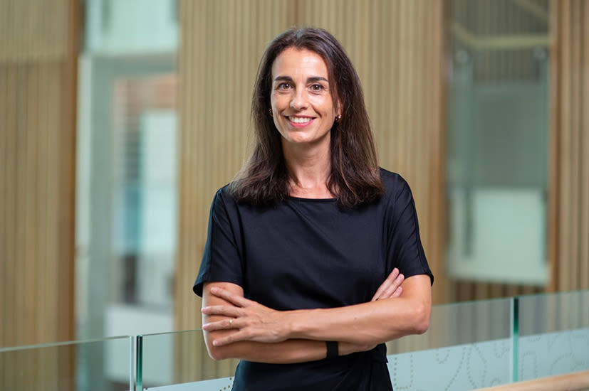 Olga Lahuerta, a Female Spanish scientist smiles at the camera, arms crossed