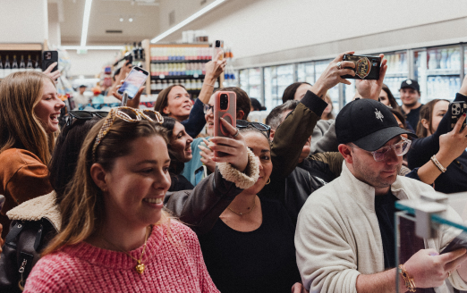 Crowd of people taking pictures with their phones