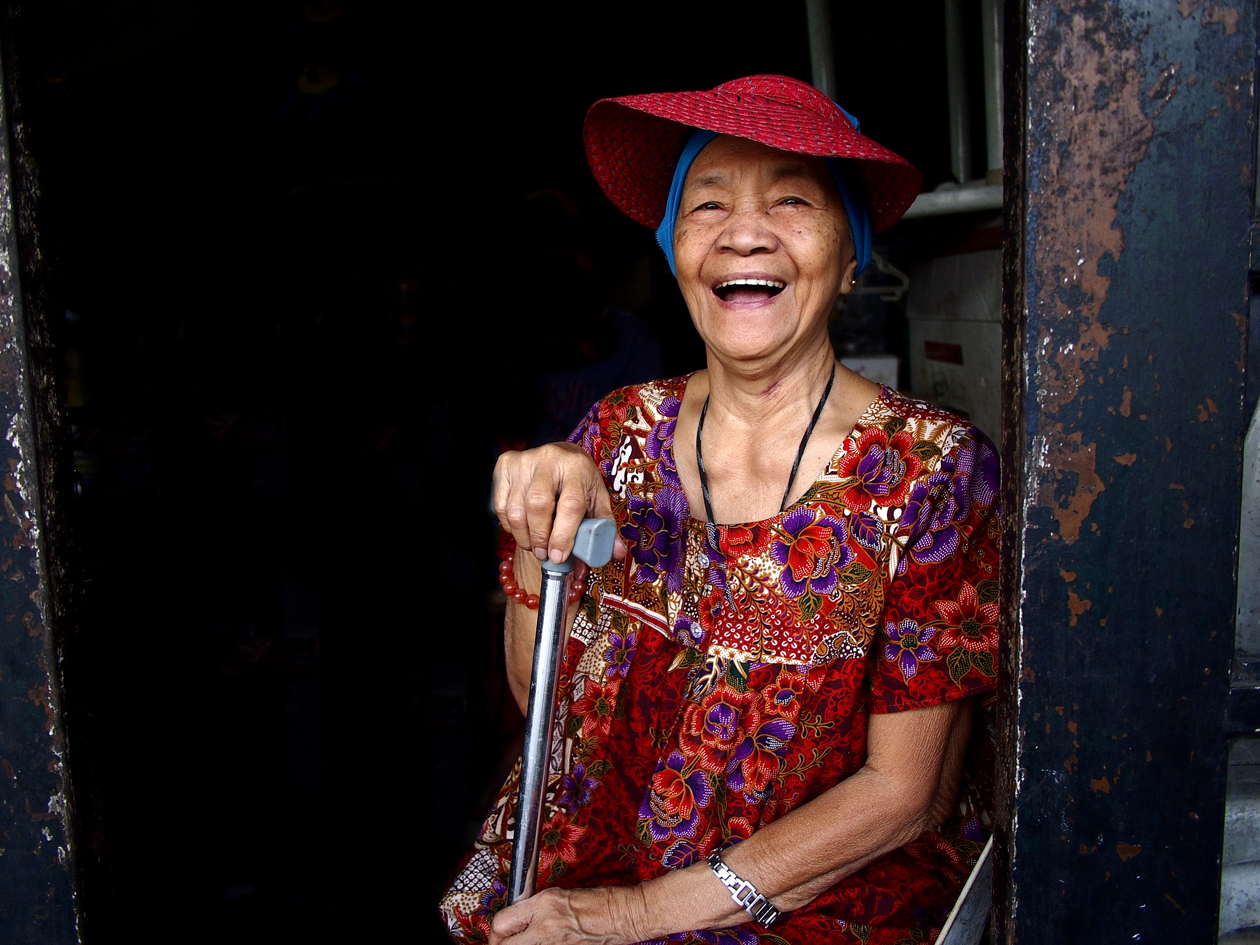 Woman smiling in Philippines holding a cane