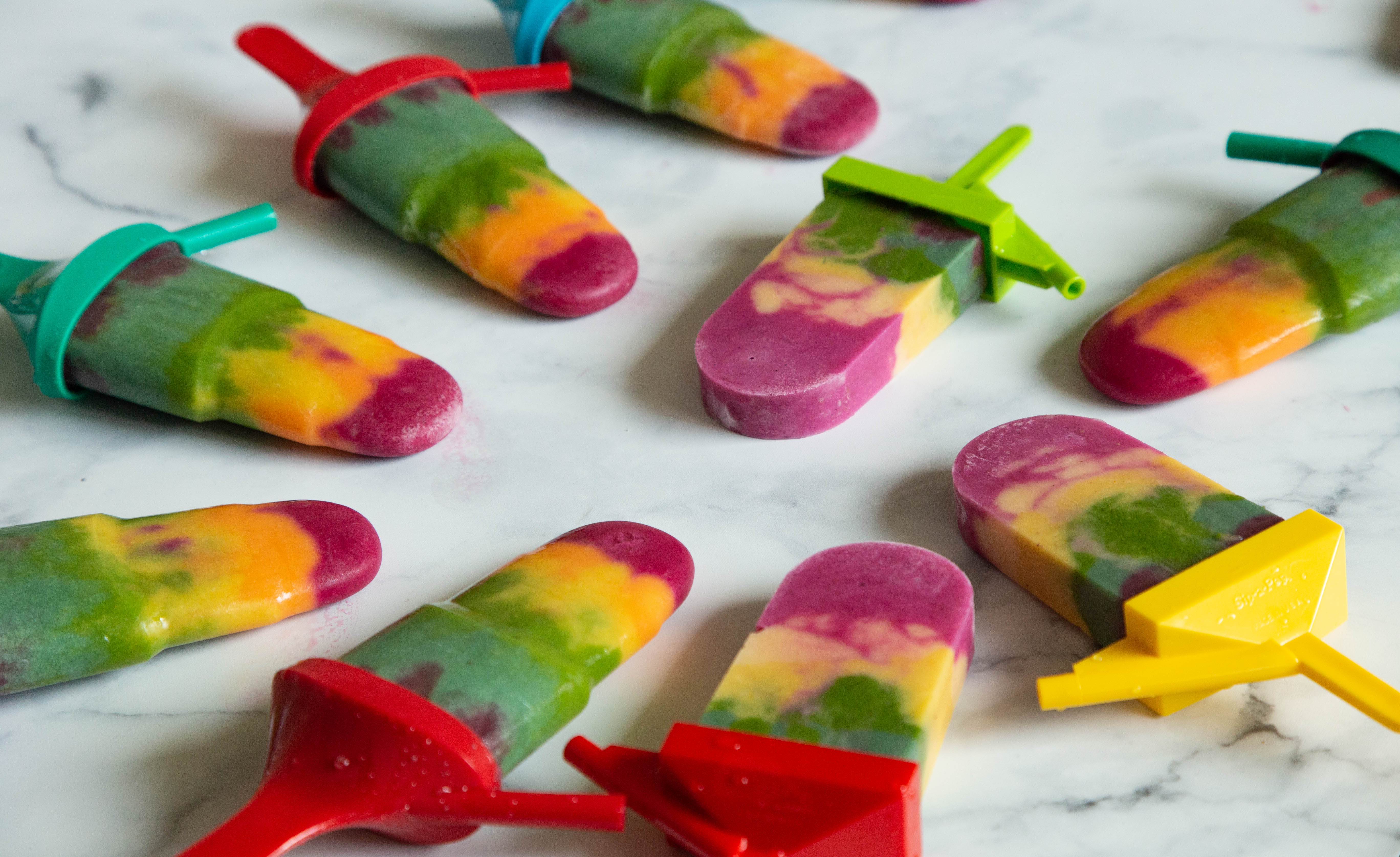 Rainbow ice cream popsicles featuring Cosmic Bliss Infinite Coconut frozen dessert