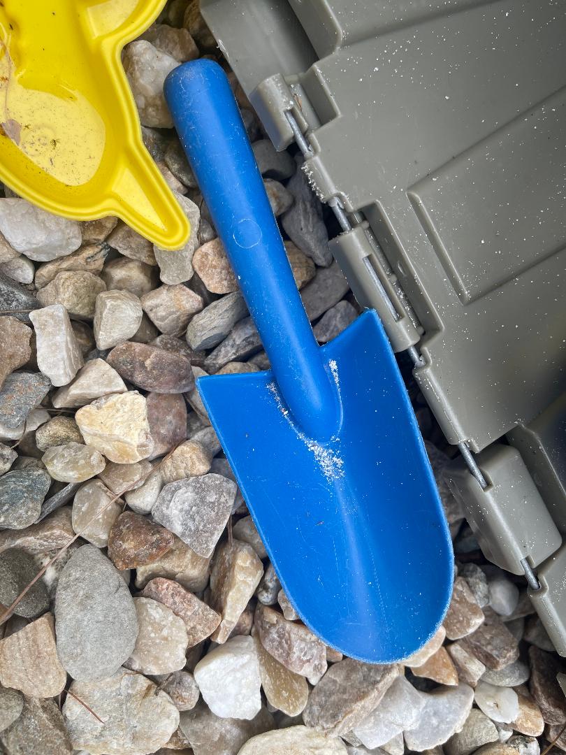 Shovels pots and cups in sand