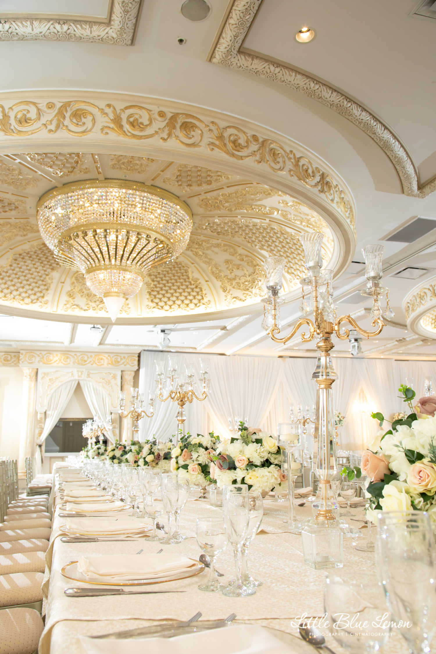 An interior shot of the Classic ballroom with a fully-plated dining table in the foreground at Paradise Banquet Halls.