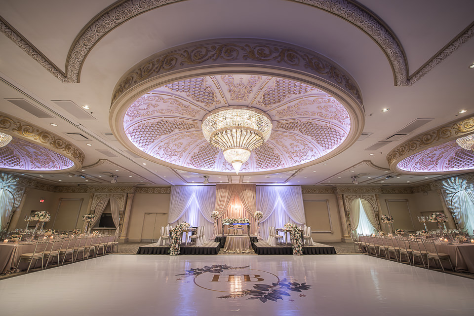 A wide angle showing the full hall with seating, chandelier, and dance floor.