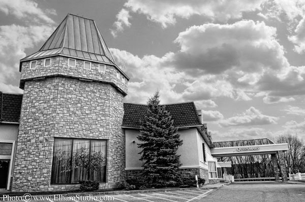 The exterior of the Paradise Banquet Halls building showing the drop-off point with an overhead structure.