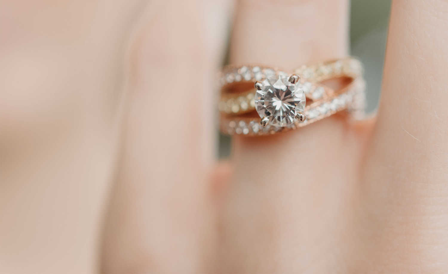 A close-up of a diamond wedding ring with a shallow depth of field.