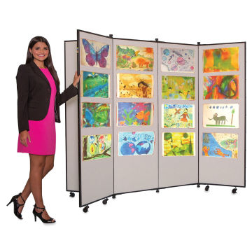 Screenflex Mobile Display - Teacher standing with 6 panel Grey display showing artwork
