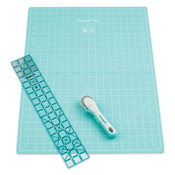 Rotary cutter with large unfolded mat and ruler laid out