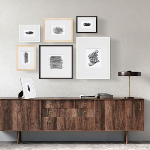 Arrangement of 6 Blick Emery Gallery Frames with Mat above table.