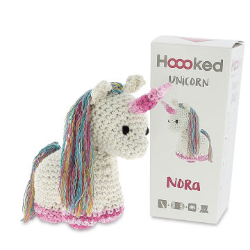 Hoooked DIY Animal Crochet Kits - Crocheted Unicorn next to package
