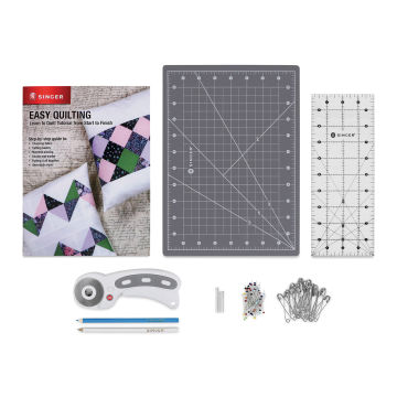 Singer Learn to Quilt Starter Kit, contents laid out next to step-by-step guide