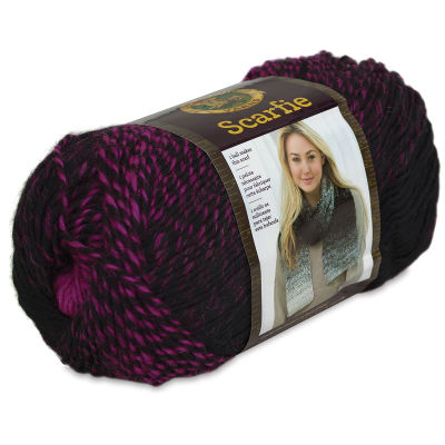 Lion Brand Scarfie Yarn - Side view of skein of Black/Hot Pink yarn with label