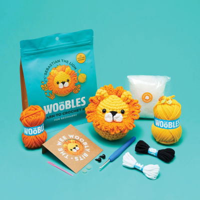 The Woobles Beginner Crochet Amigurumi Kits - Lion (kit contents with finished project and packaging)