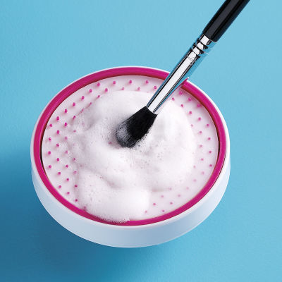 Sigma Beauty SigMagic Scrub - Makeup brush being cleaned in suds
