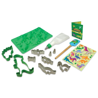 Handstand Kitchen Ultimate Baking Party Set - Dinosaur, bakeware and recipe book laid out.