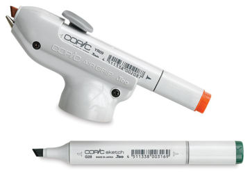Copic Air Grip with Orange Copic marker loaded, and Green Copic marker nearby (Markers not Included)