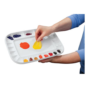 Mijello Artelier Peel-off Palette - Artist's hand peeling paint off used Palette