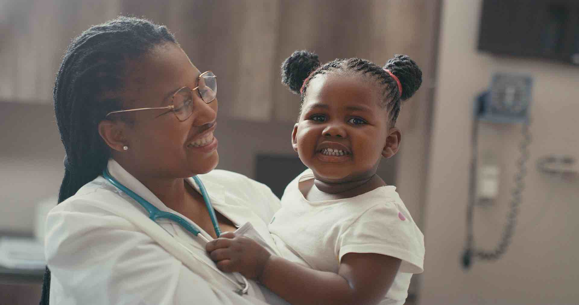 Doctor holding child