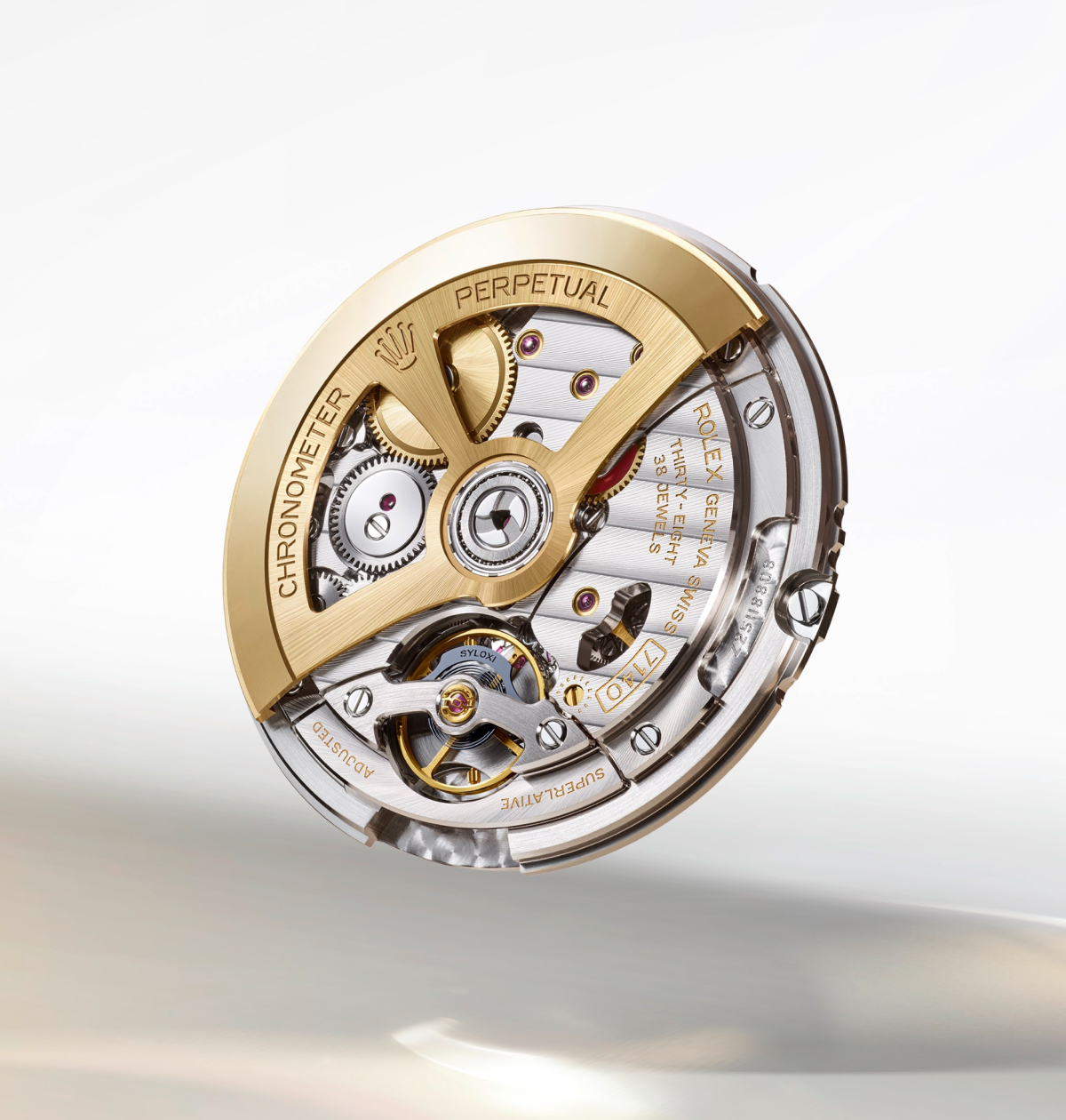 Close-up of a Rolex watch movement showcasing detailed inner mechanisms. Visible are cogs, gears, jewels, and engravings in gold and silver tones, with the words "Chronometer", "Perpetual", and "Rolex" prominently displayed. The background is a light gradient.