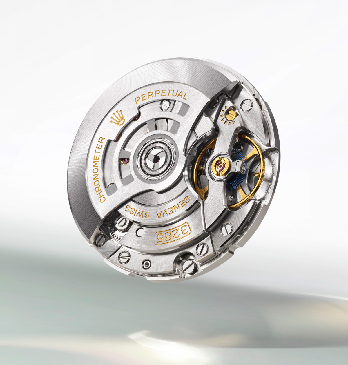Close-up of a sophisticated and detailed mechanical watch movement. The circular mechanism features intricate gears, polished metal parts, and engraved inscriptions including "PERPETUAL," "GENEVA SWISS," and "CHRONOMETER.