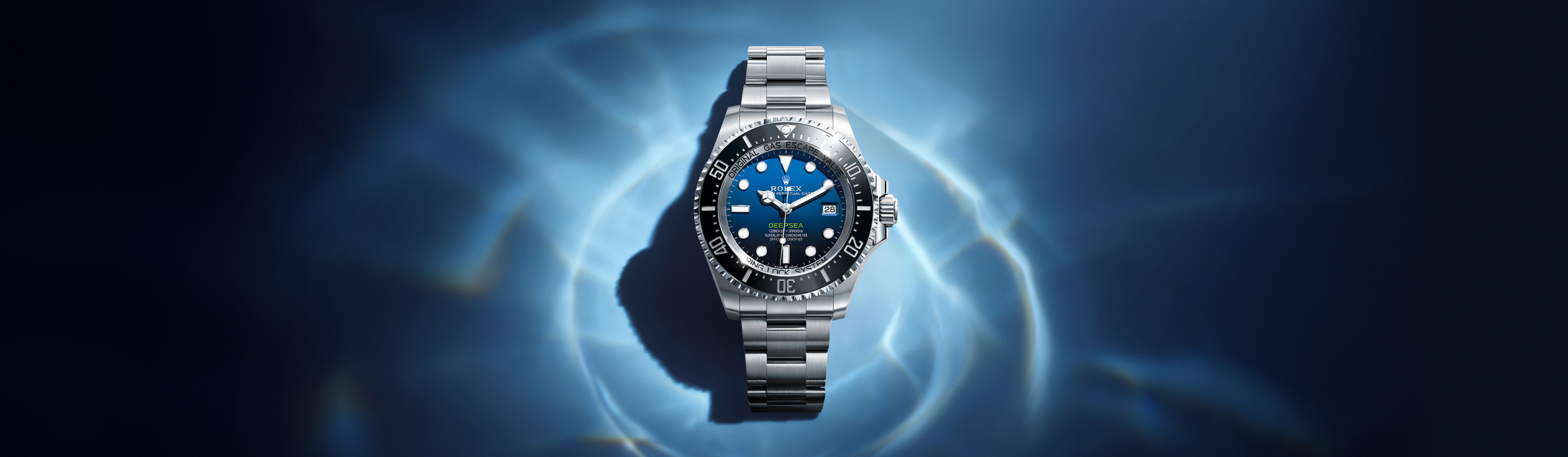 A luxurious gold wristwatch with a blue dial and a date display, positioned under a spotlight against a dark, misty background, creating an elegant and sophisticated ambiance.