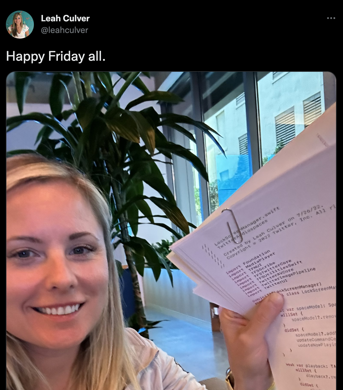 Engineer showing printed out source code wishing a happy friday
