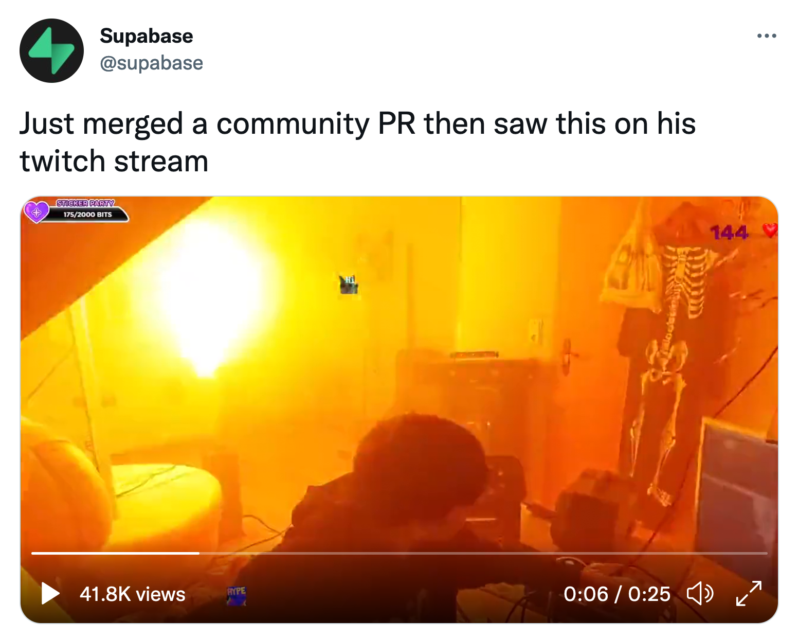 Tweet: "Just merged a community PR then saw this on his twitch stream" including a video with a kid having fire in the background.