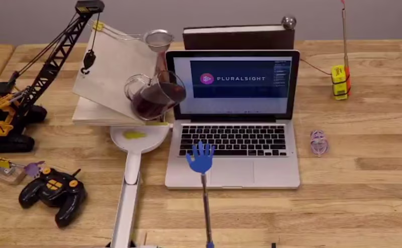 Construction around a MacBook and a cup of coffee is almost puring over it.