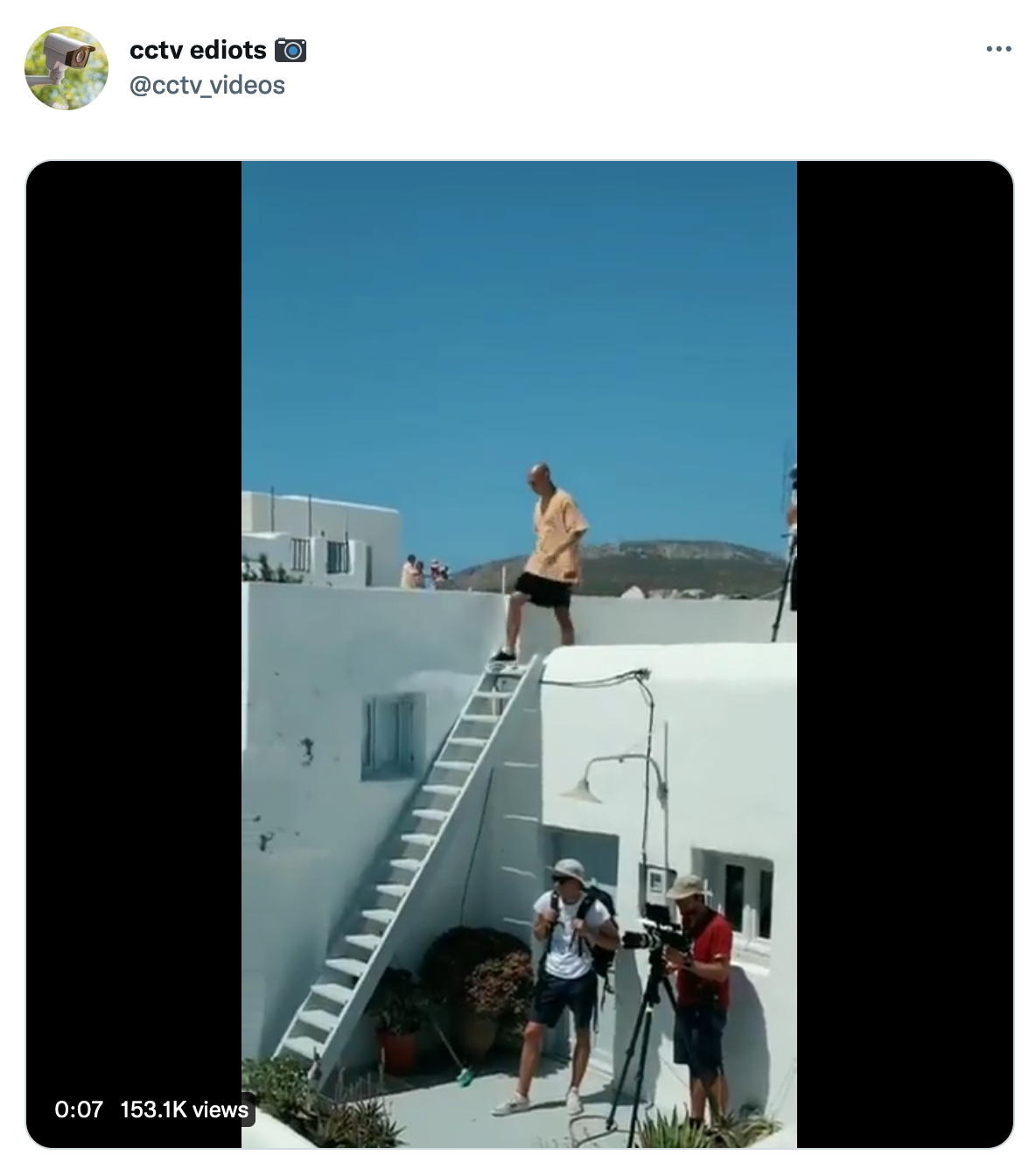 Tweet showing a man about to go down some stairs.
