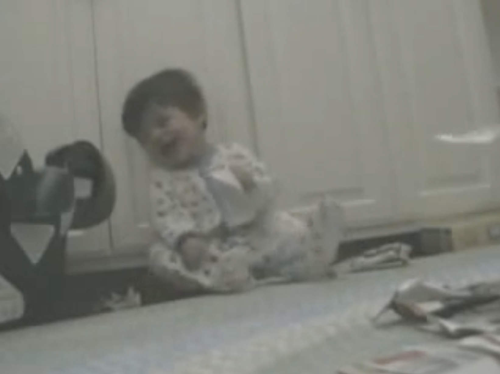 Baby laughing about paper.