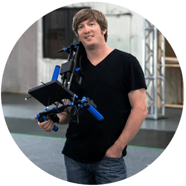 Photo of Brett Ineson holding a production tool related to his work at Animatrik Film Design