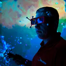 Man wearing virtual reality glasses with a space-like background