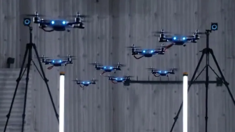 8 drones flying on a set with OptiTrack cameras in the background
