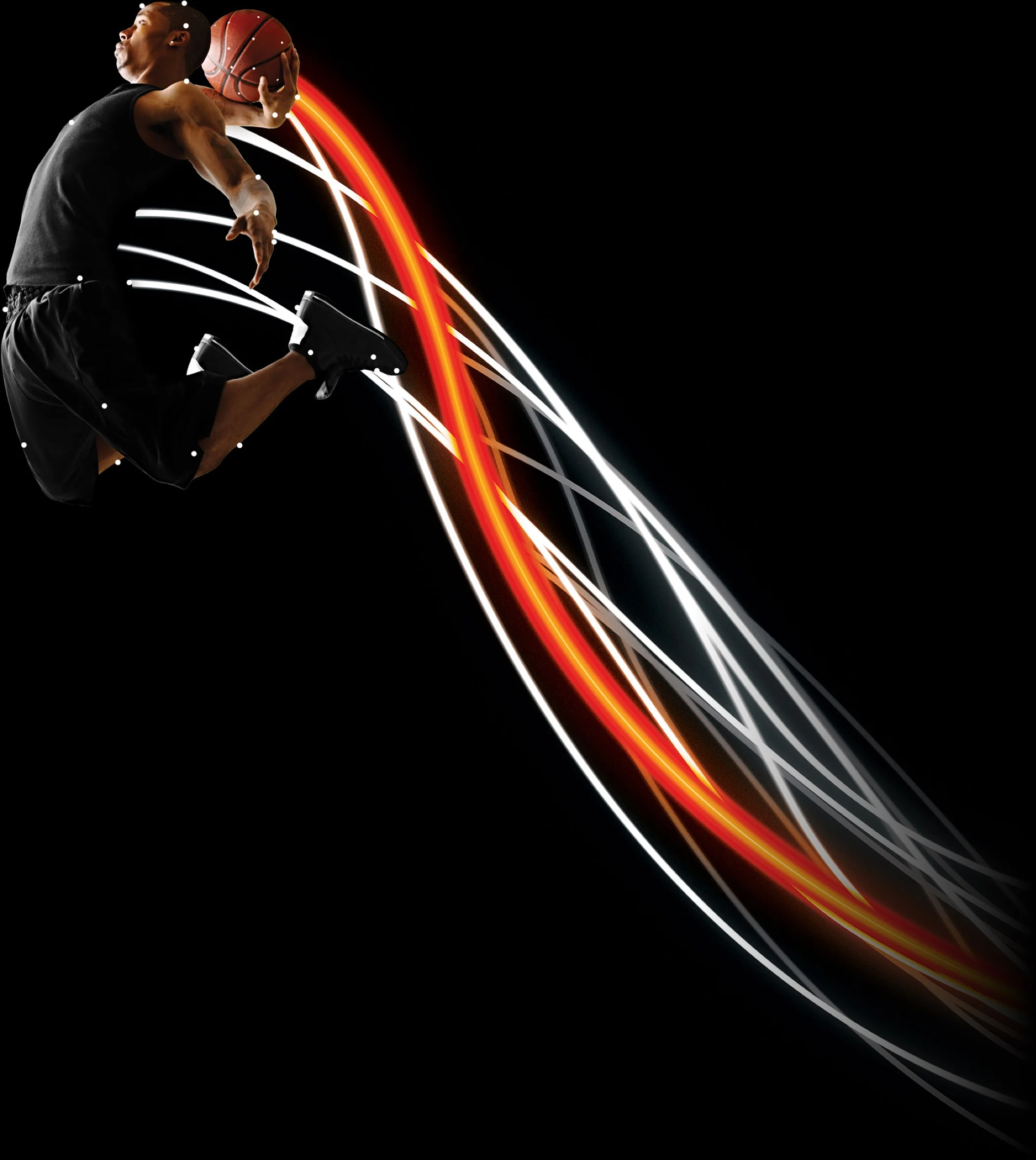 Basketball player in process of dunking a basketball. Has computer-generated tracers coming off the player behind him.