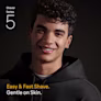 Smiling young man with curly black hair wearing a black hoodie. Smiling young man with curly black hair wearing a black hoodie.