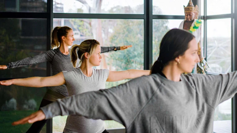 Three women doing yoga