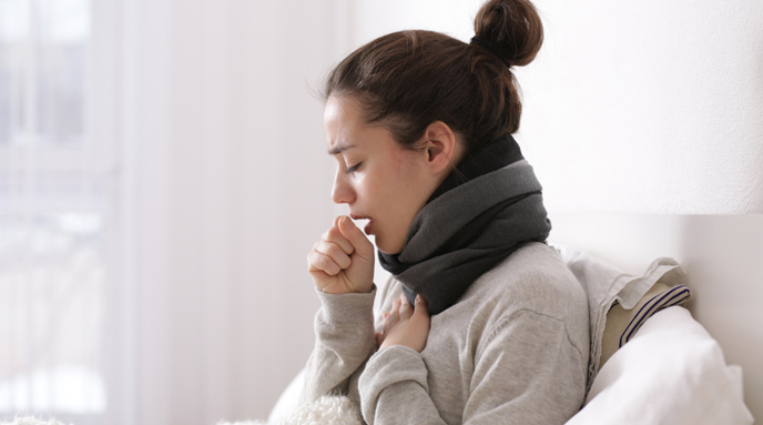 Lady experiencing dry cough symptoms