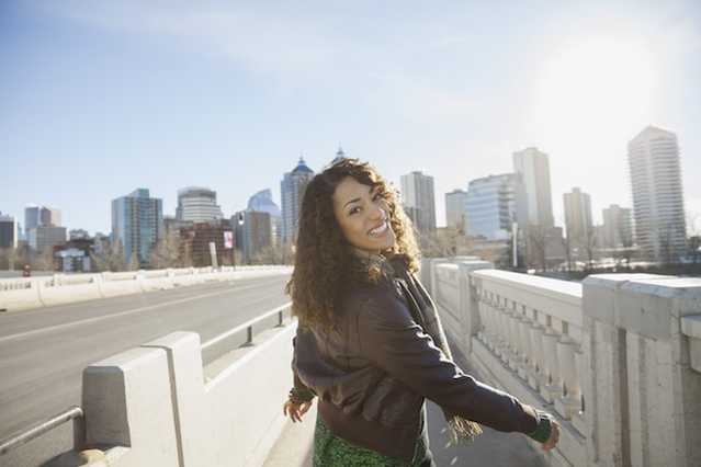 Woman smiling walking through a city