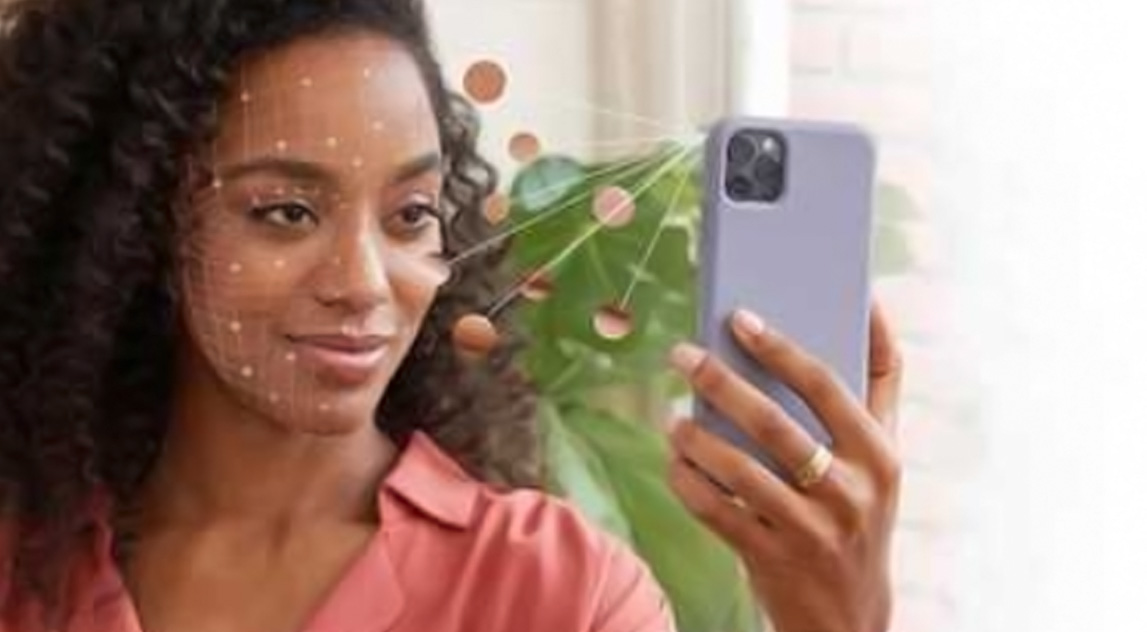 Women holding phone towards face to use Neutrogena Skin360 Application