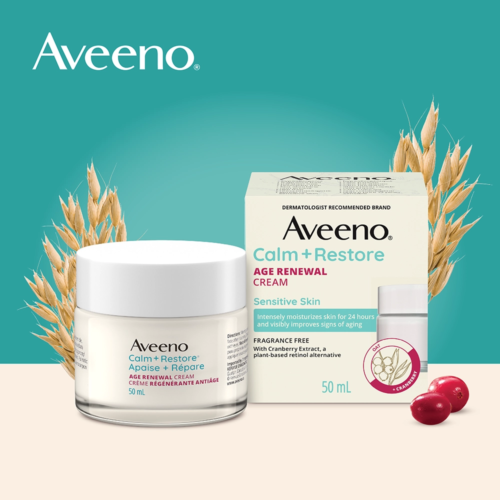 The front shot of the AVEENO® Calm + Restore Age Renewal Face Cream product jar and packaging along with oats and cranberries