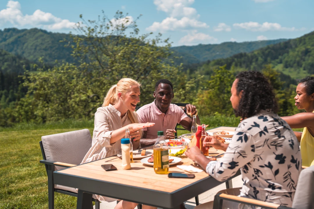 Group of people eating and talking together outside