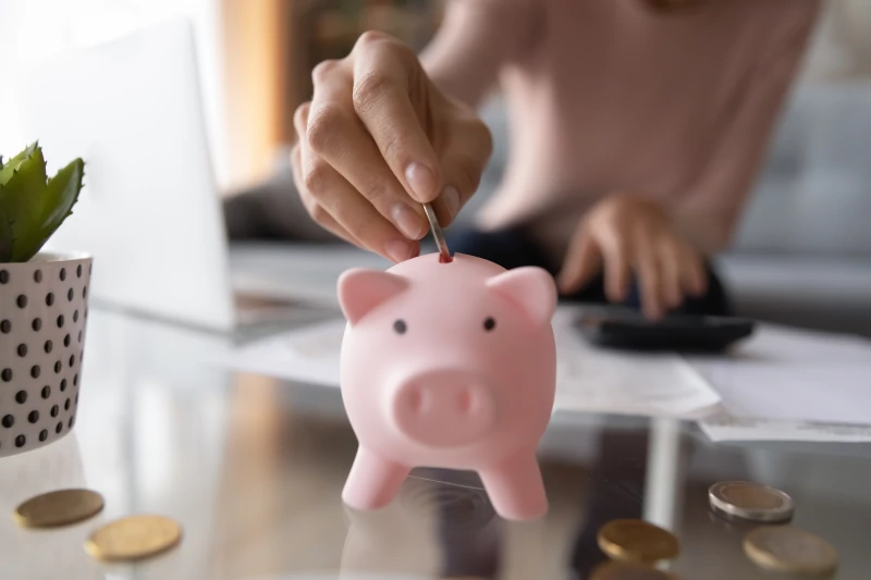 Coin being placed into piggy bank