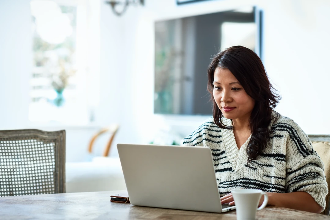 A woman typing on a laptop