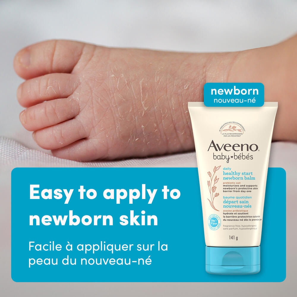 Front shot of Aveeno® Baby Healthy Start Newborn Balm, 141g, squeeze tube, and baby's foot at the background