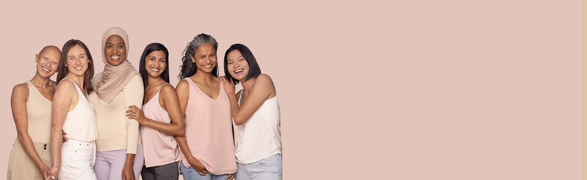 Six women from different ethnicities are standing together and smiling