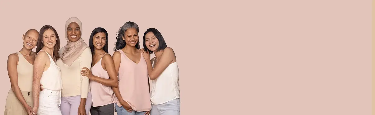 Six women from different ethnicities are standing together and smiling