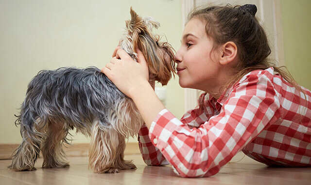 Girl playing with her dog